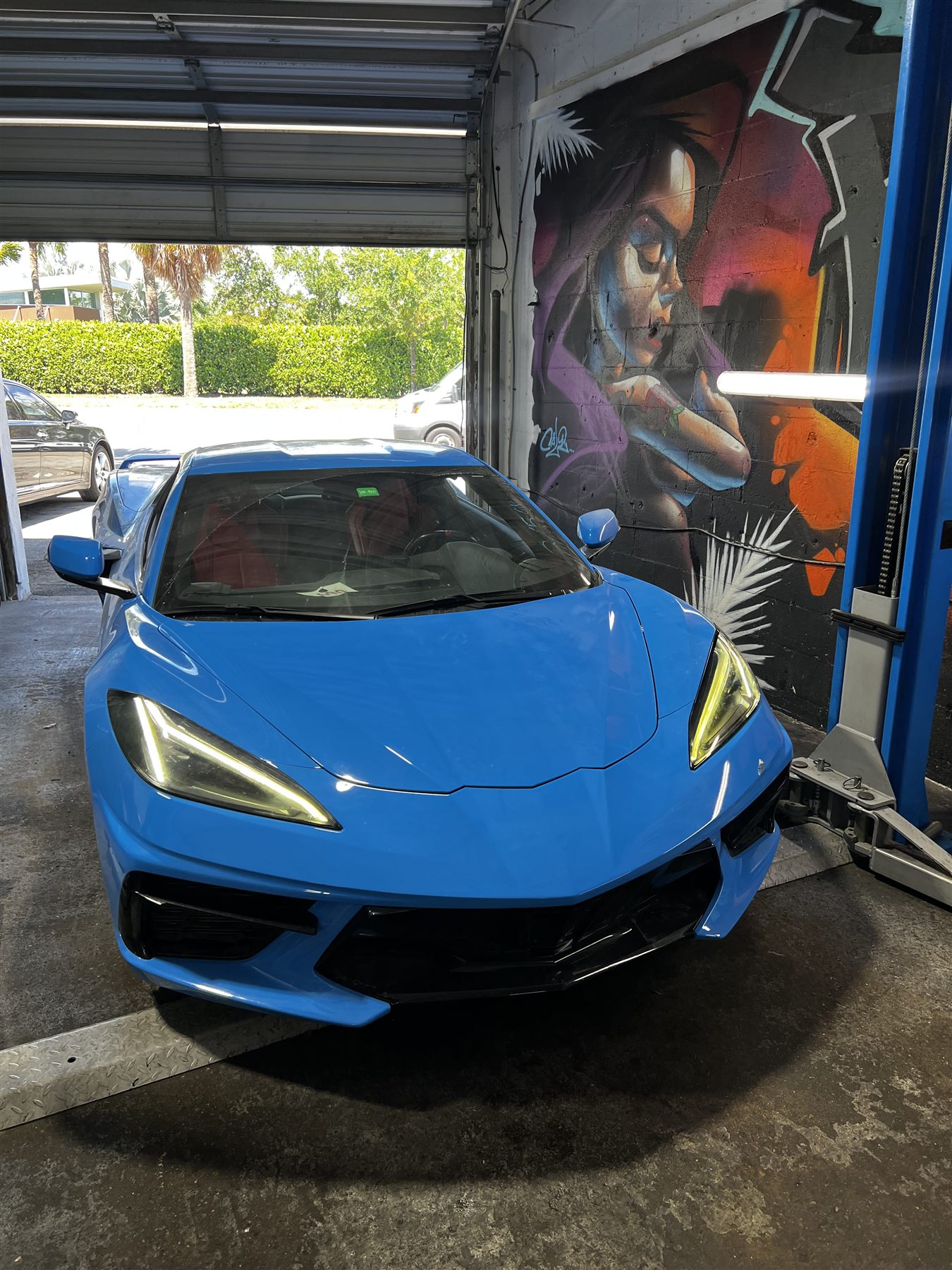 Blue Chevrolet Corvette in the service bay